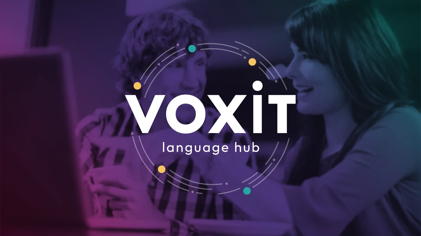 Voxit language hub brand applied over a classroom photo, with the ring of colored dots around the logotype